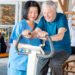 image of RT working with patient on exercise bike